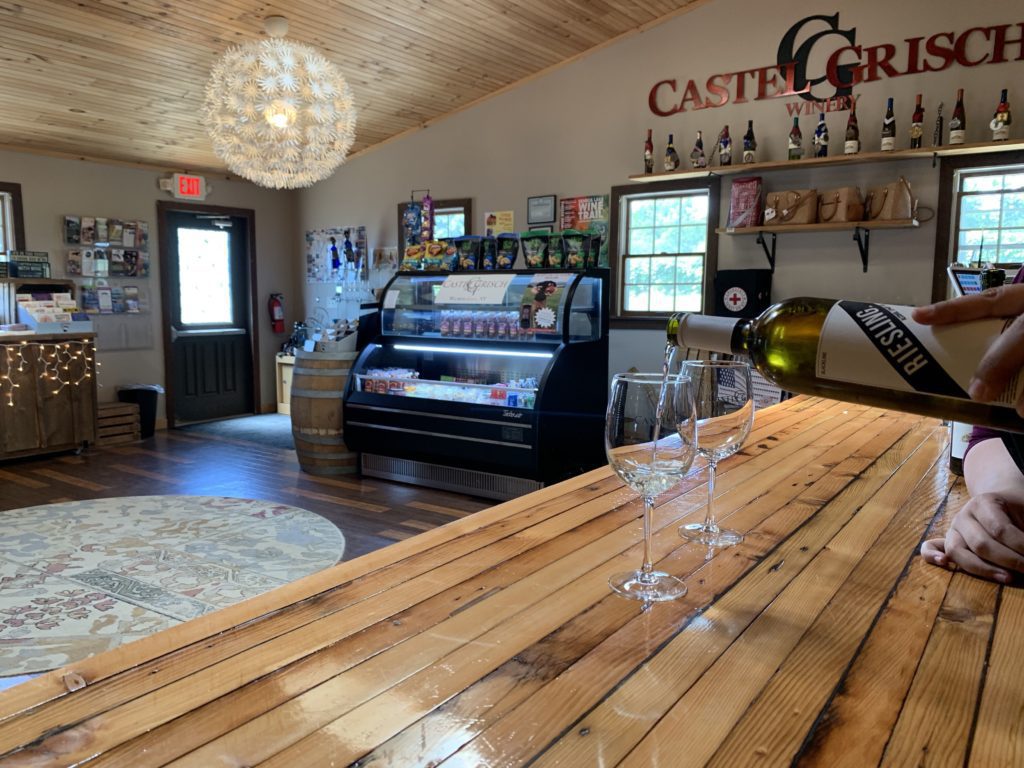 Glasses of Reisling wine being poured at the interior bar at Castel Grisch winery