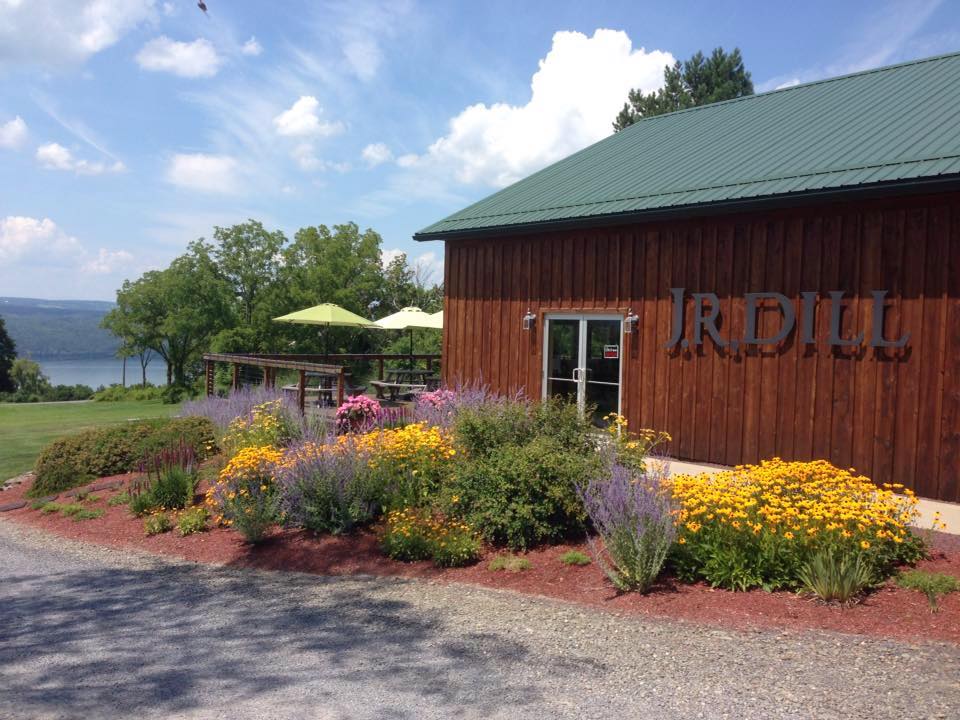 Winery building with flowers, picnic tables, and umbrellas