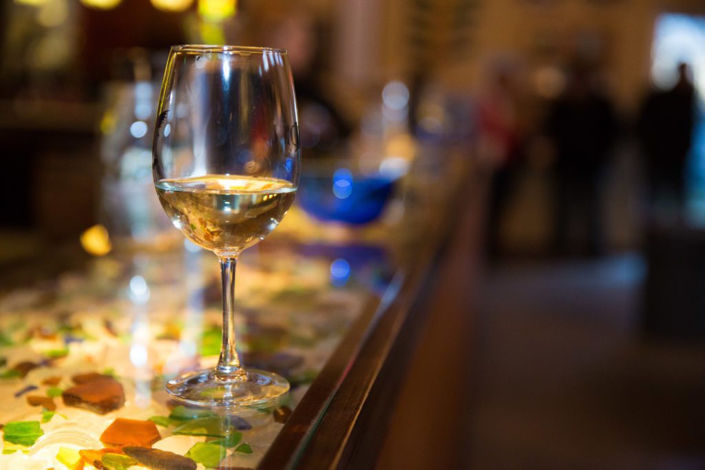 Wine glass on a colorful tasting bar