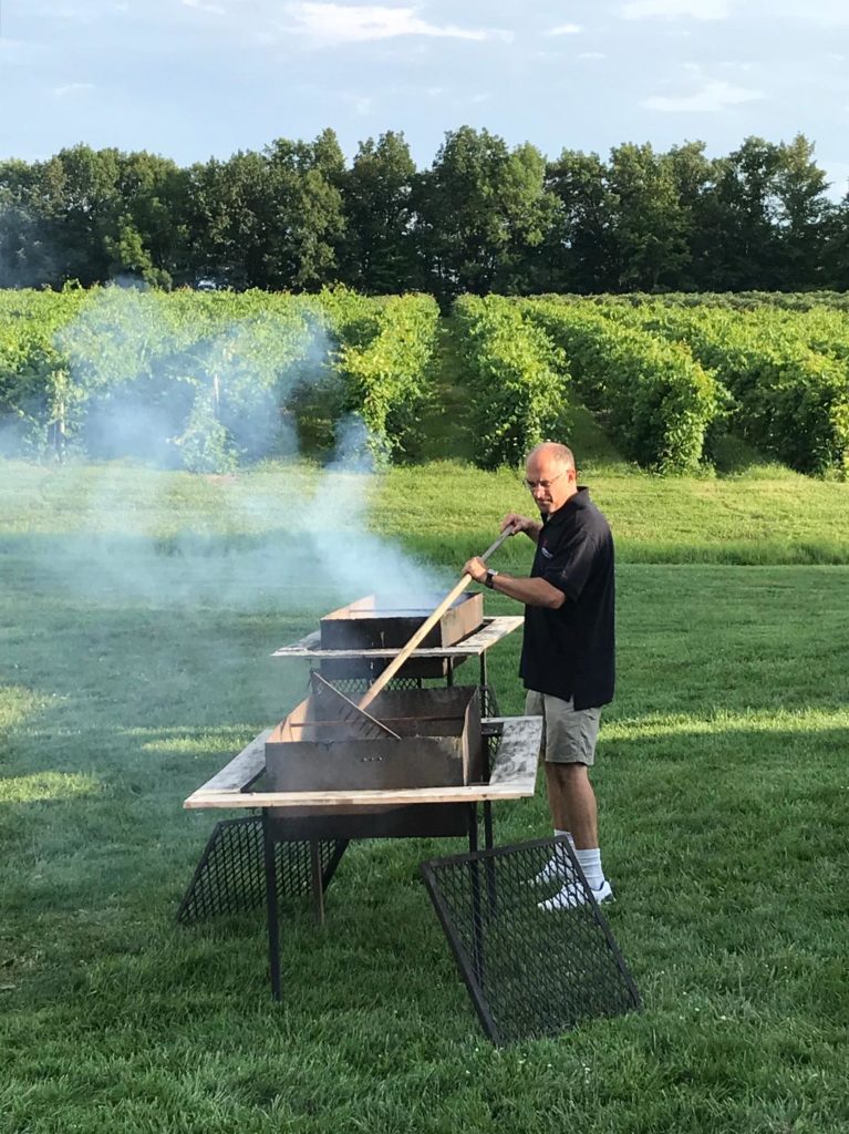 Man preparing grill for steaks