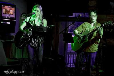 Woman singing and man playing guitar