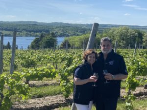 Man and woman standing in vineyard