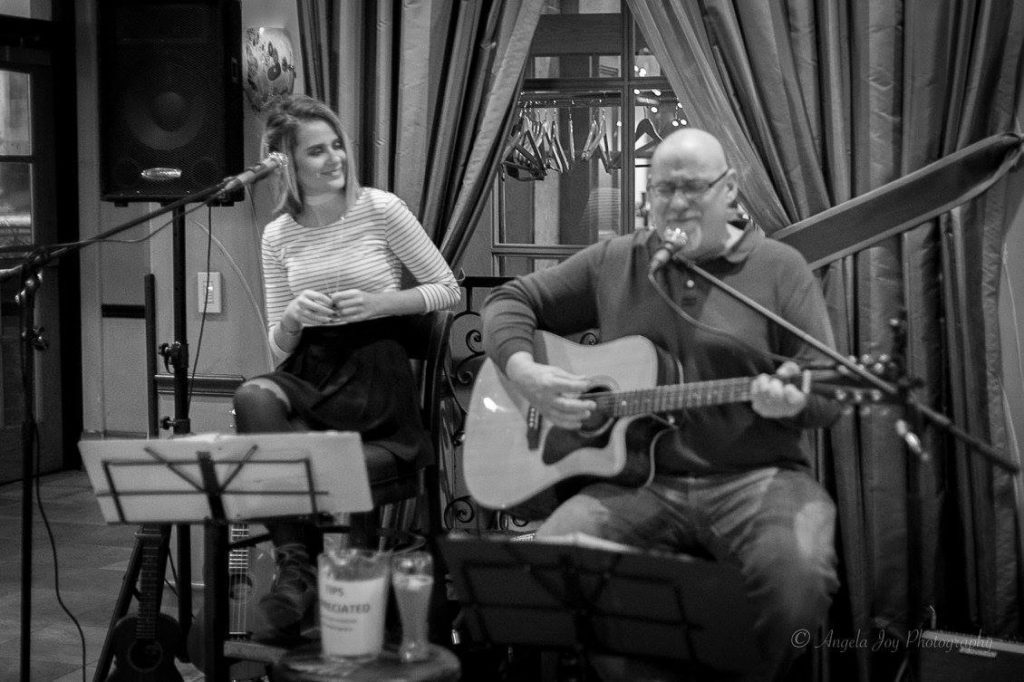 man playin guitar, woman singing