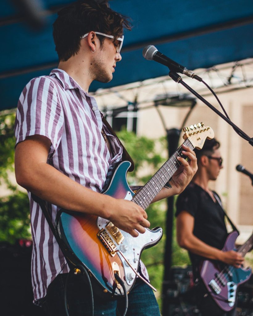 2 men playing guitar