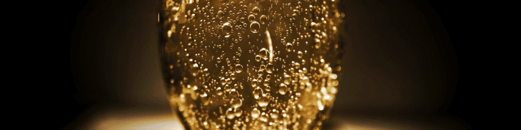 Black background with sparkling wine in the foreground