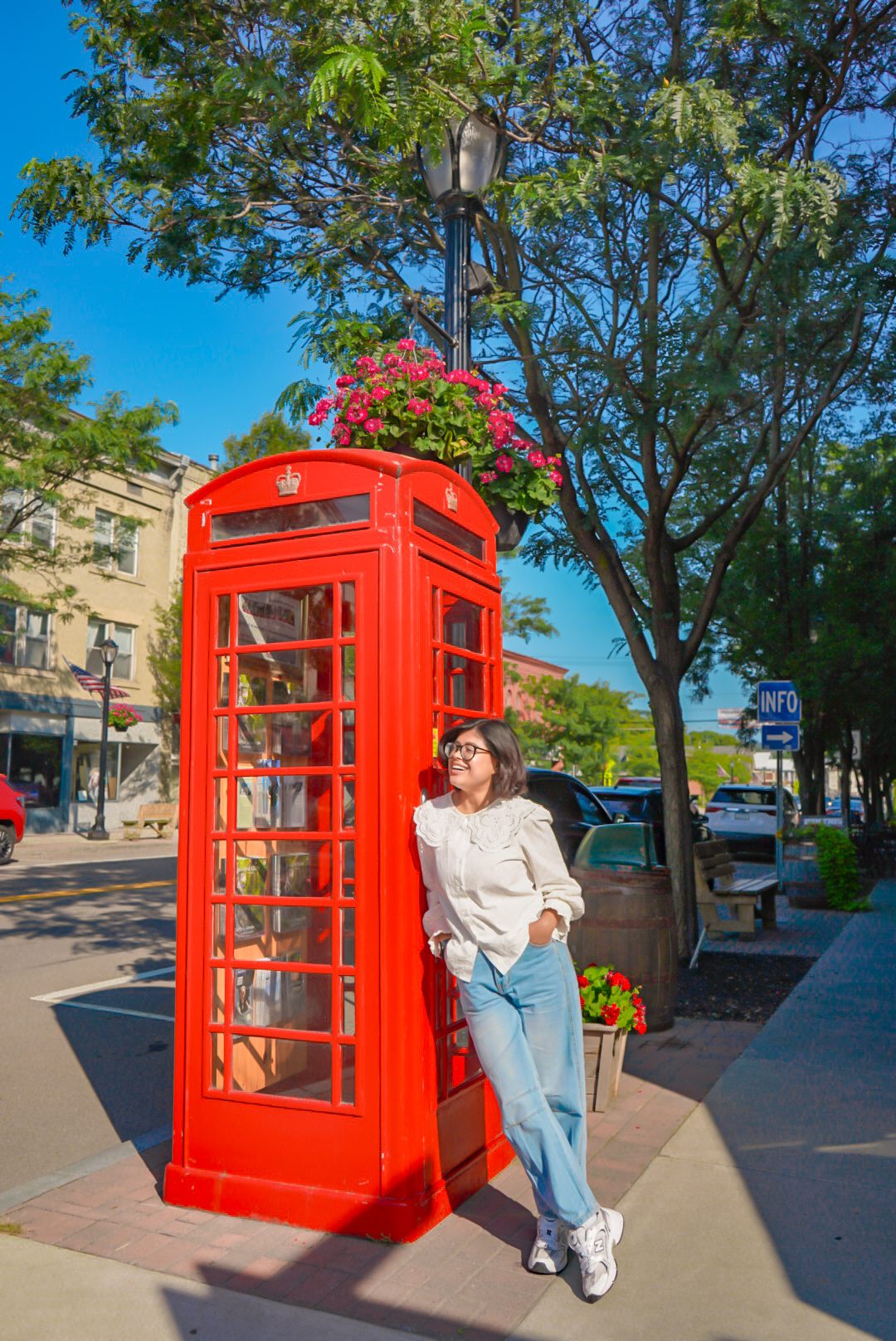 Pustika Samaddar standing next to a red telephone booth