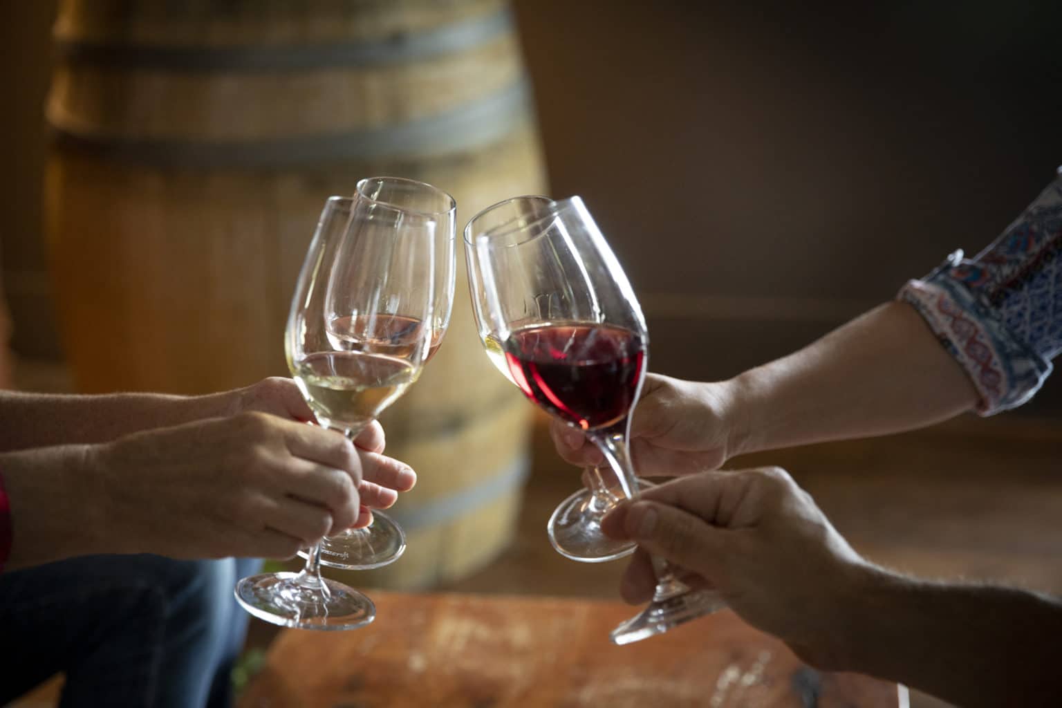 Four wine glasses toasting