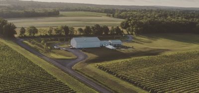 Aerial view of Boundary Breaks tasting room, white building surrounded by vineyards and trees