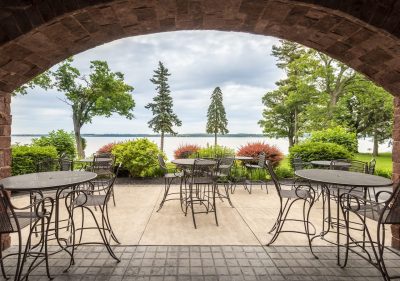 Outdoor seating area at Belhurst Castle winery with a stunning view of Seneca Lake