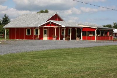 View of tasting room from the road - red building with yellow trim