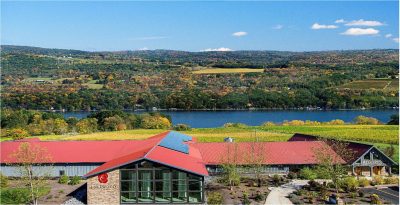 Lakewood Vineyards building red roof, blue building with vineyards and lake in the background