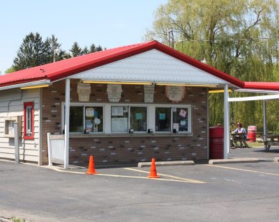 Mr. Twistee's Ice Cream Stand. White and brick building with red roof.