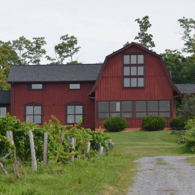 Enjoy a tastings in a restored barn and grape packing house overlooking vineyards and Seneca Lake at Caywood Vineyards