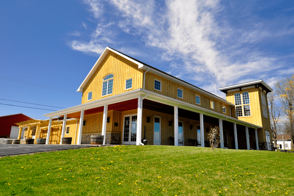 Exterior of the farm style yellow main building at Fulkerson Winery