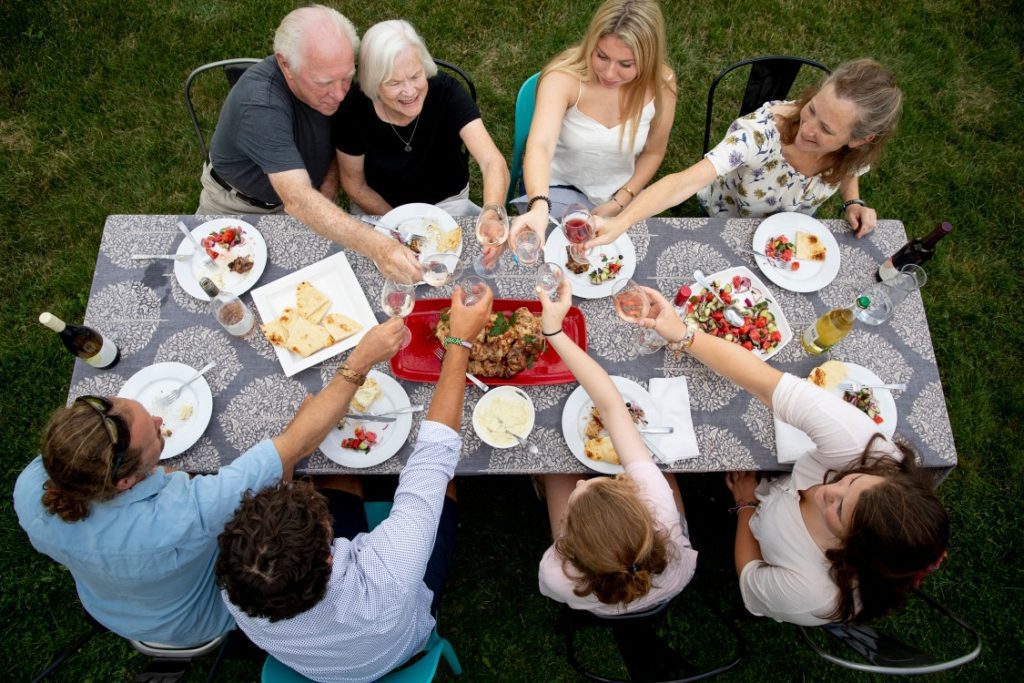 People enjoying a dinner with delicious food and wine during a stop at Seneca Lake wine tour